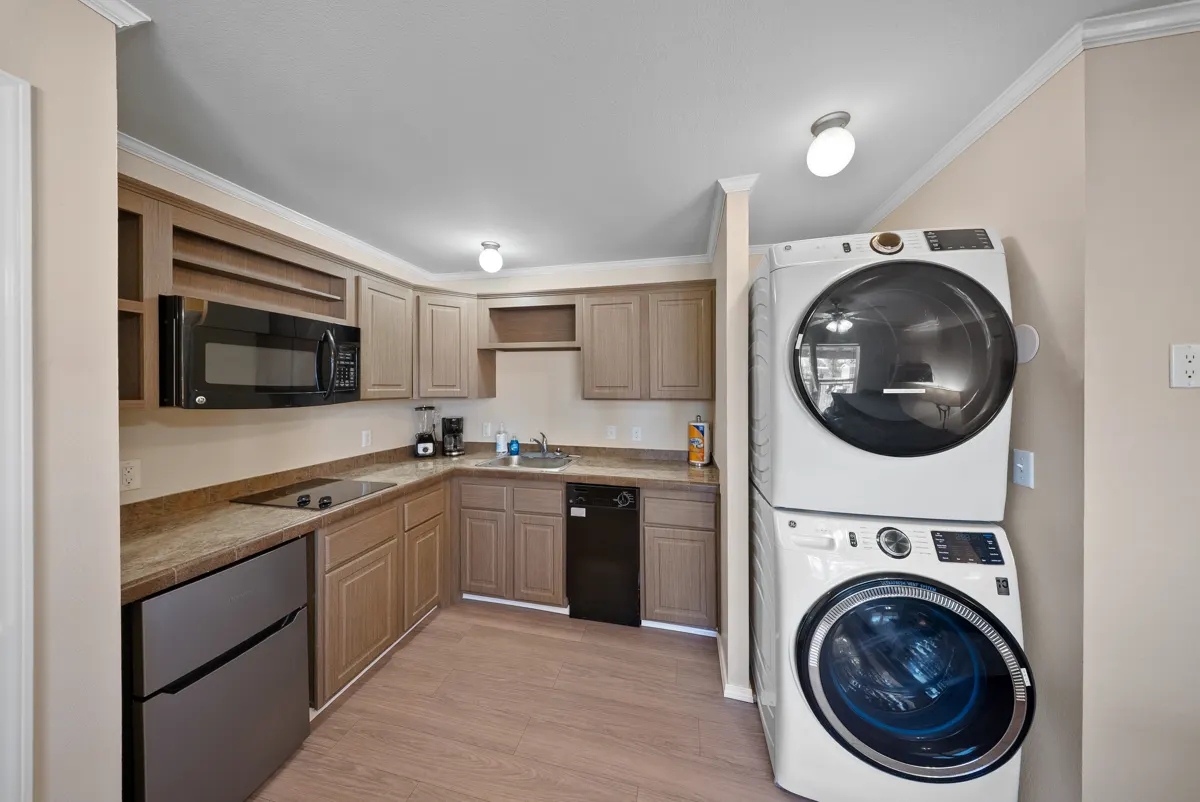Cypress kitchenette with stacked laundry